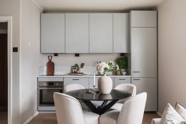 Lekkert og moderne kjøkken med slette fronter med laminert benkeplate og nedfelt oppvaskkum av stål.